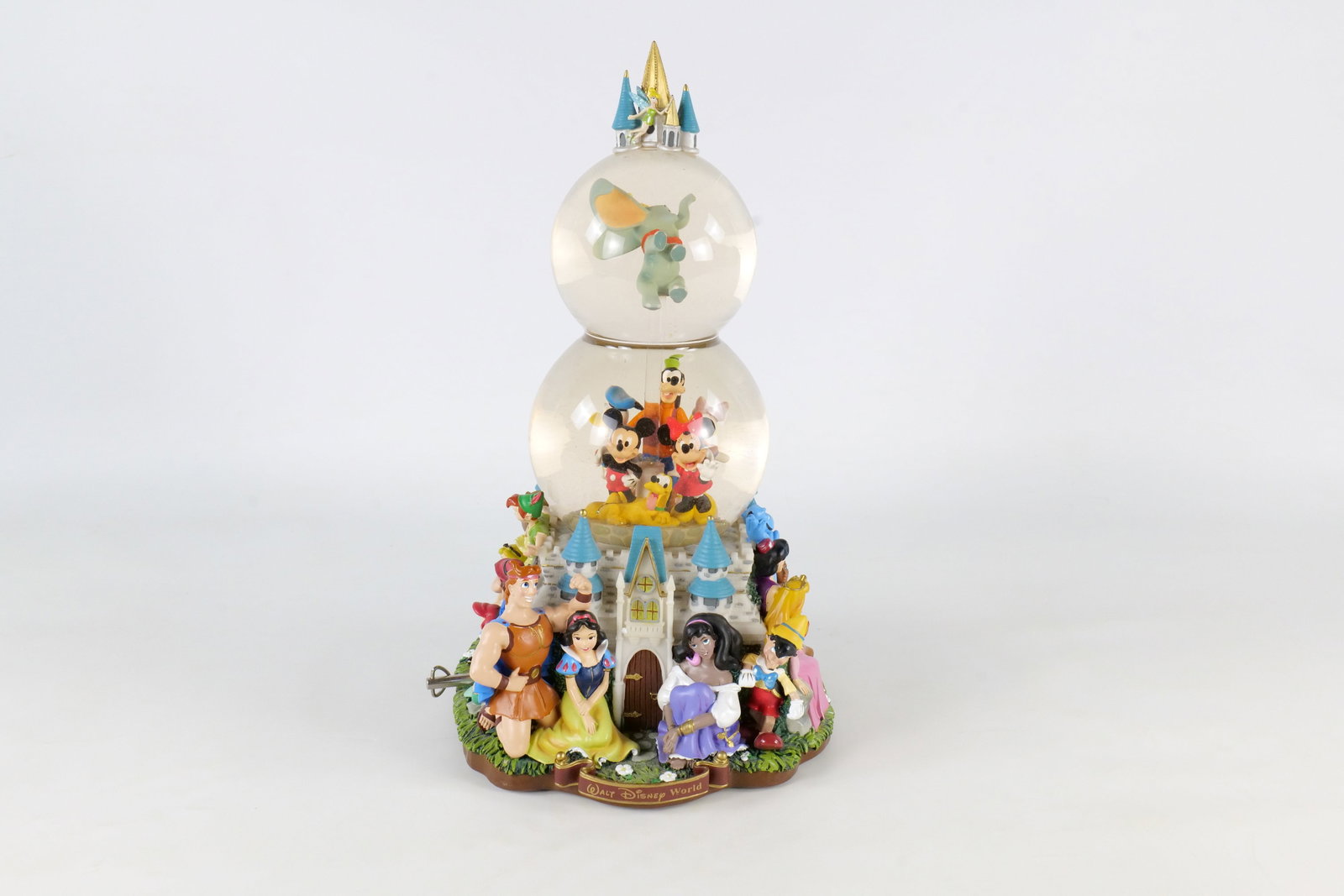 Disney Character Parade Musical Light Up Double Snow Globe: Disney Character Parade Musical Light Up Double Snow Globe. Spinning feature on the inside. Tested with batteries - lights up and plays music. Measures 14 inches tall by 7 1/2 inches wide. All invoice