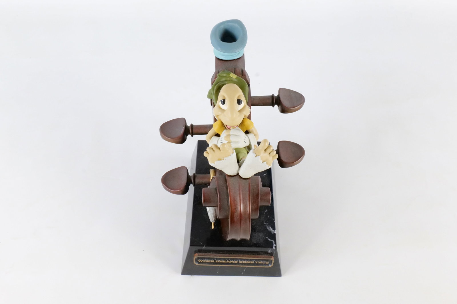 Bill Toma "When Dreams Come True" Bronze Statue: Bill Toma "When Dreams Come True" Bronze Statue. Depicting Jiminy Cricket lounging on a musical instrument. Comes atop a marble base. Signed Bill Toma #46 of 75. Measures 7 1/2 inches tall by 9 1/2 in