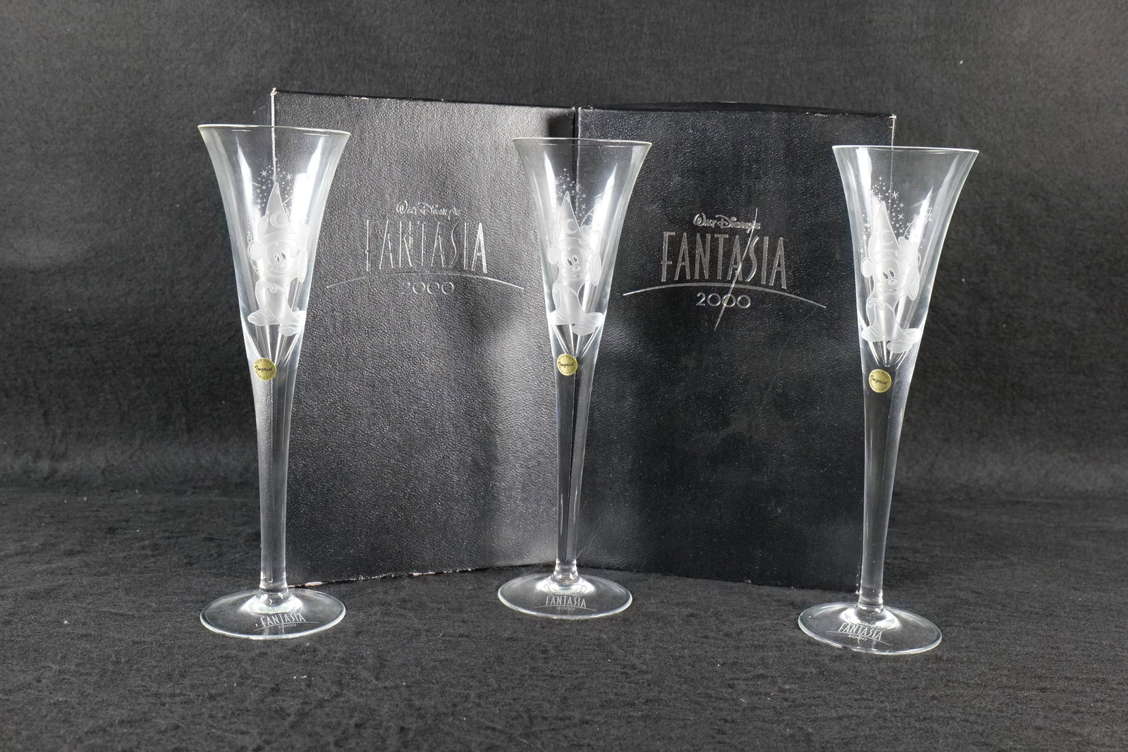 Lot of 3 Ingrid Bohemian Glass Disney Fantasia 2000 Champagne Flutes: Lot of 3 Ingrid Bohemian Glass Disney Fantasia 2000 Champagne Flutes. Depicting images of Sorcerer Mickey Mouse and a music note on the backside. This lot is a set of 2 with original box and then one 
