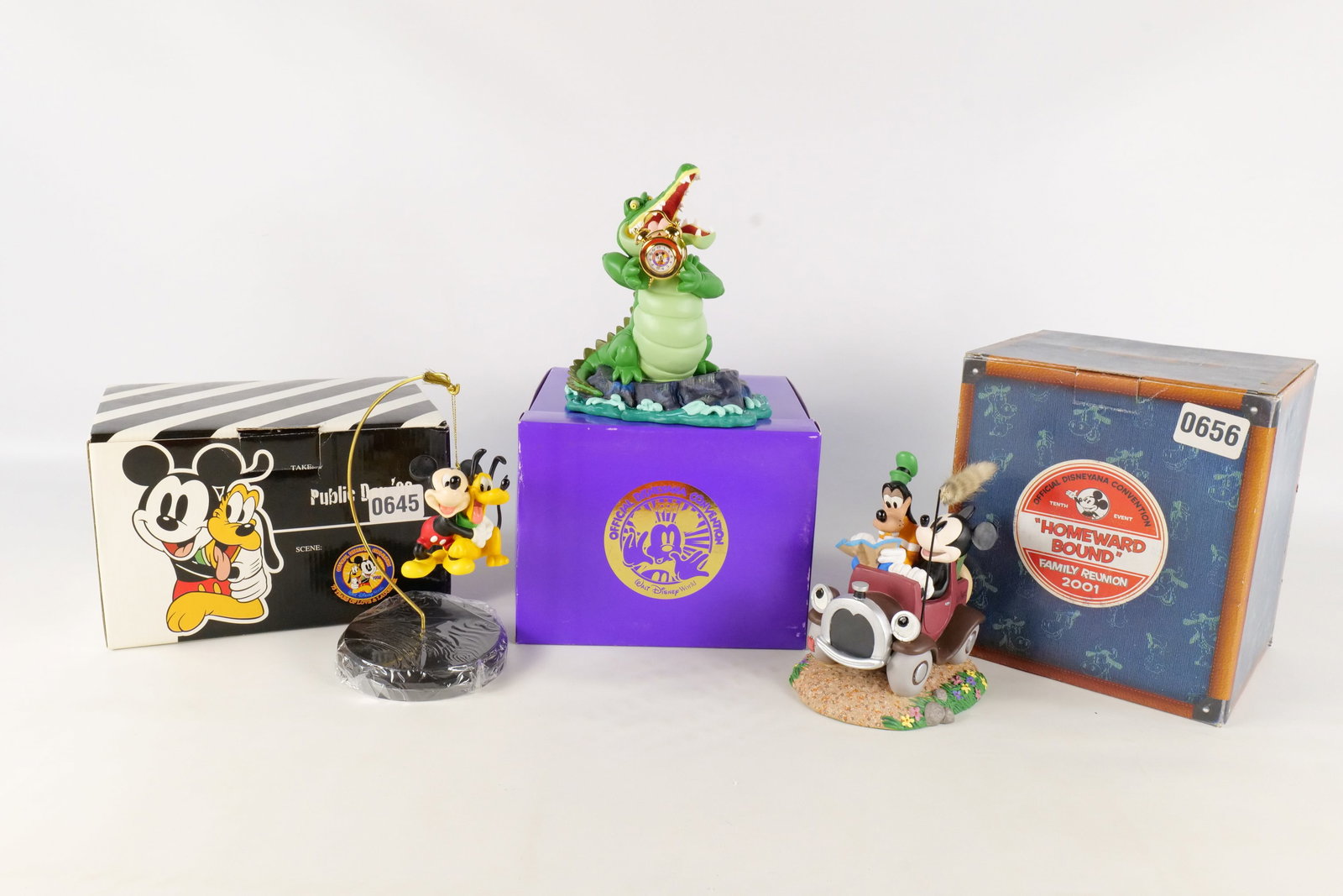Lot of 3 Disneyana Figurines: Lot of 3 Disneyana Figurines. Including 1997 Tick Tock Clock Peter Pan Figure, 2001 Homeward Bound Mickey and Goofy Figure, and 1998 Public Day Mickey and Pluto Ornament with Stand. Tallest figurine m