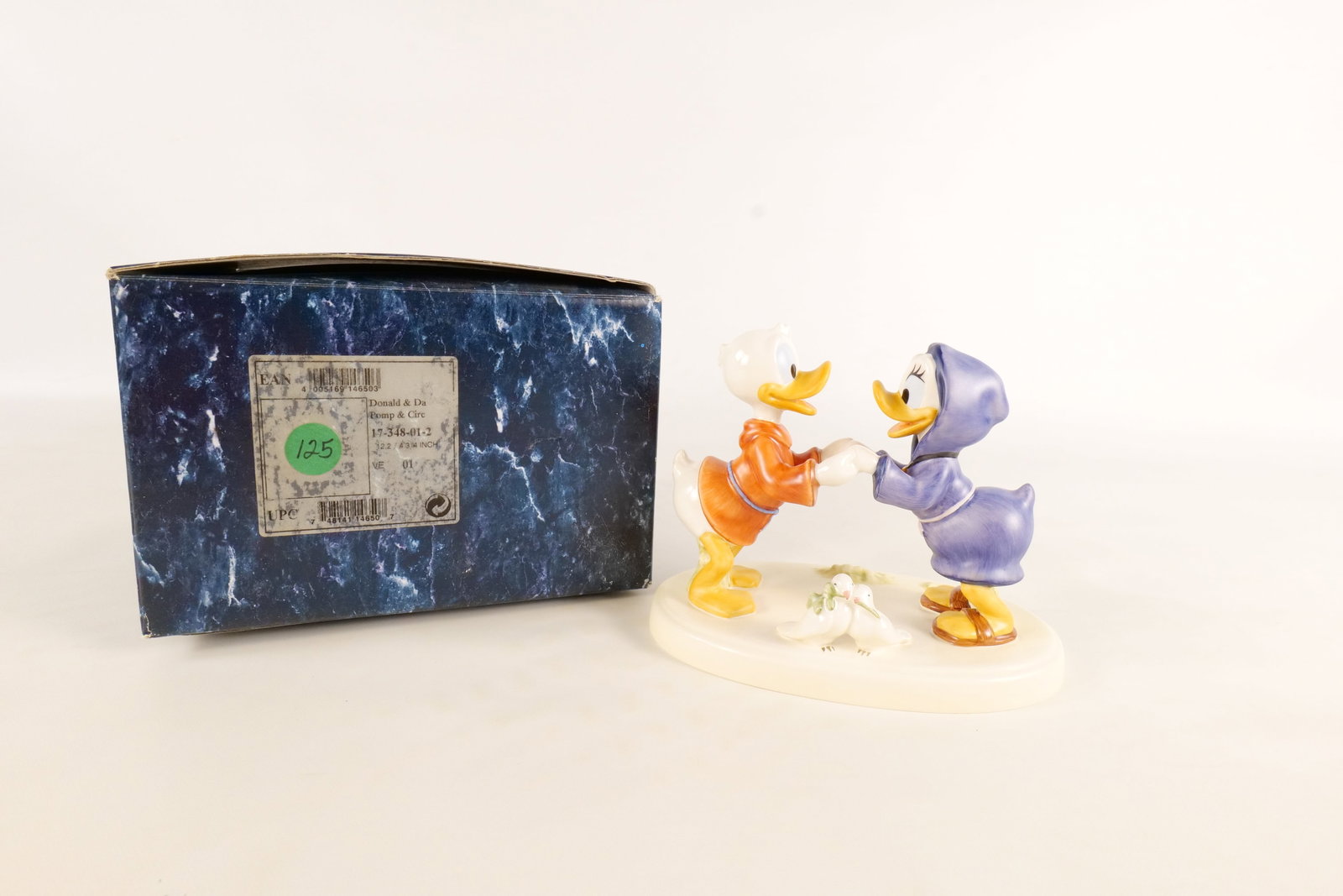 Goebel Daisy and Donald Duck "Pomp and Circumstance" Figurine: 1999 Disneyana Convention Goebel Daisy and Donald Duck "Pomp and Circumstance" Limited Edition Figurine. #125 of 350. Artist signed on underside of base. Measures 5.25 inches tall by 6 1/82 inches wid