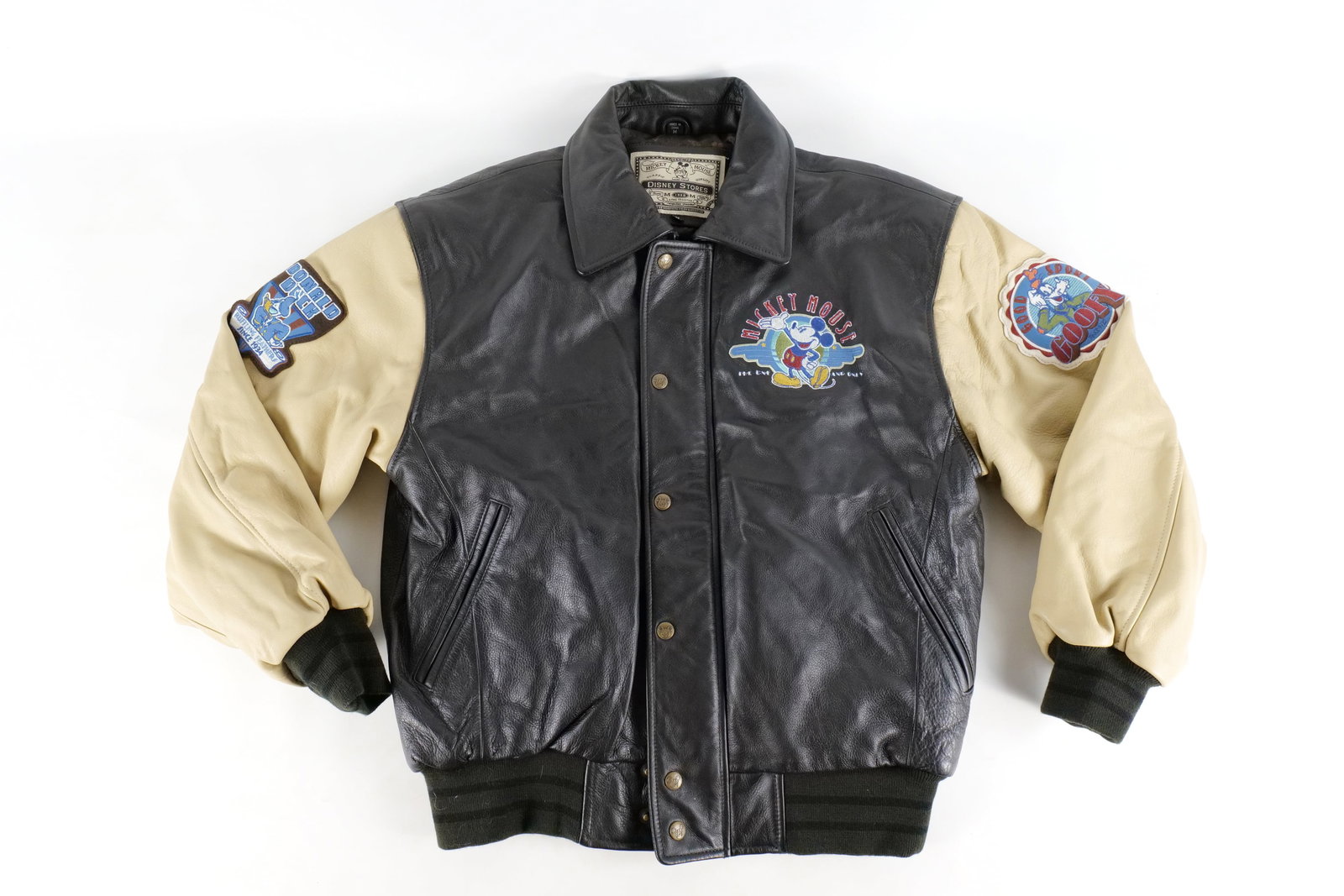 Walt Disney Animation Studio Leather Patchwork Jacket: Walt Disney Animation Studio Leather Patchwork Jacket. Disney Store tags. Size medium. Featuring Mickey, Donald Duck Goofy and Pluto. Shell is made of 100% genuine leather. All invoices must be paid w