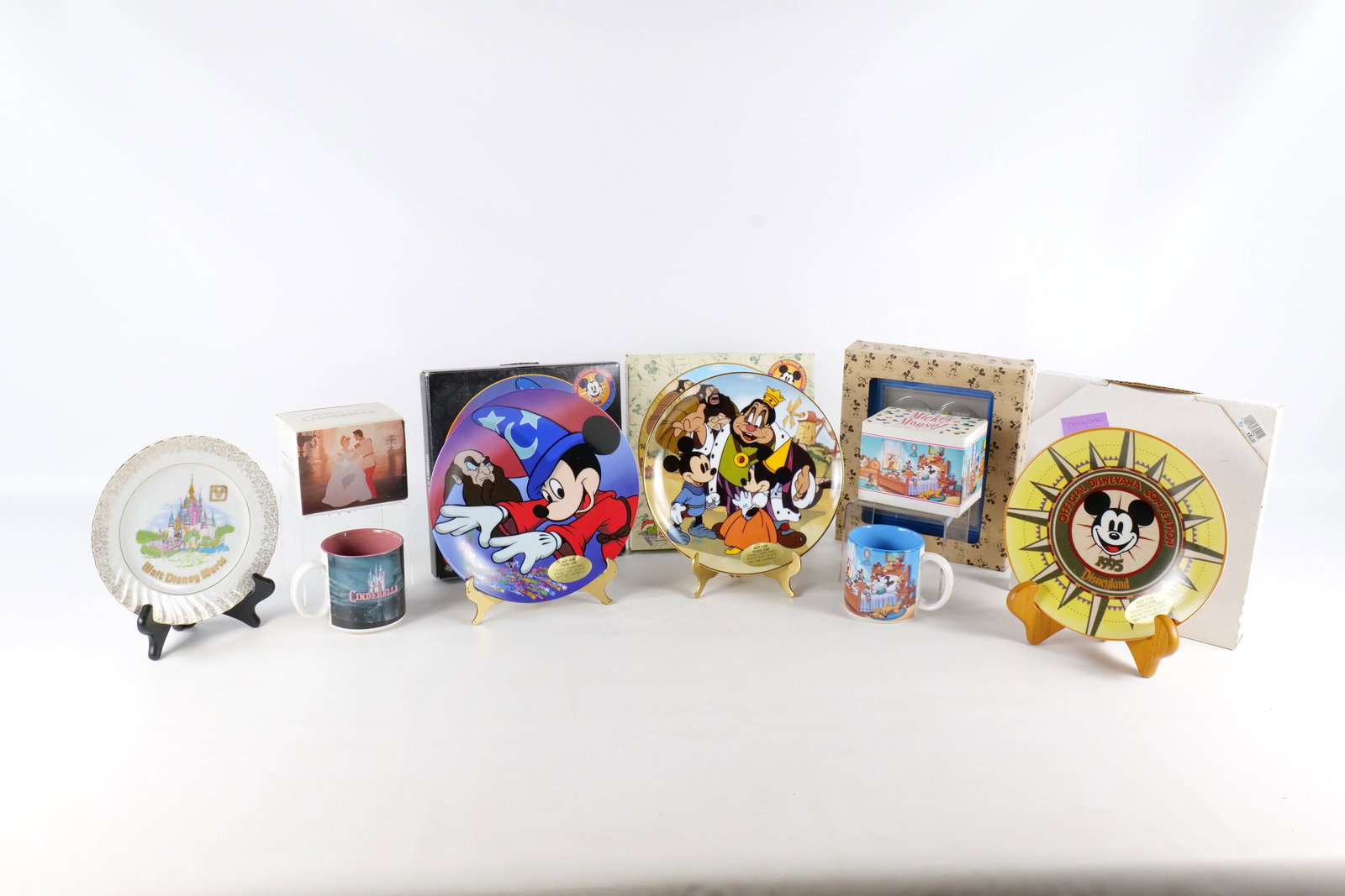 Lot of Disney Collectibles: Lot of Disney Collectibles. Including Magnet Frame, Cinderella Mug, Mickey Mouse Through the Years Mug, and Various Collector Plates . Most come in original box. All invoices must be paid within 24