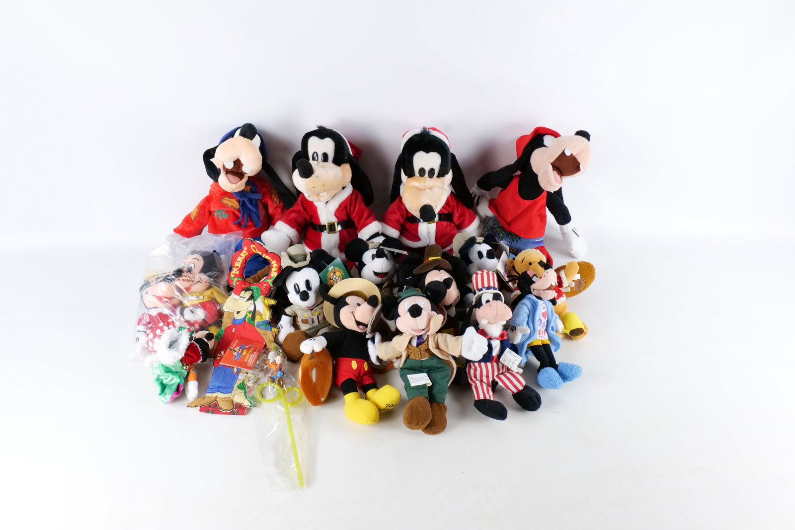 Lot of Disney Store Bean Bag Plush: Lot of Disney Store Bean Bag Plush. Including Pilgrim Mickey, Safari Mickey, Minnie and Mickey Sweetheart Set, Large Goofy Santa, Winnie the Pooh in a Christmas Sweater, and more. Almost all have Disn