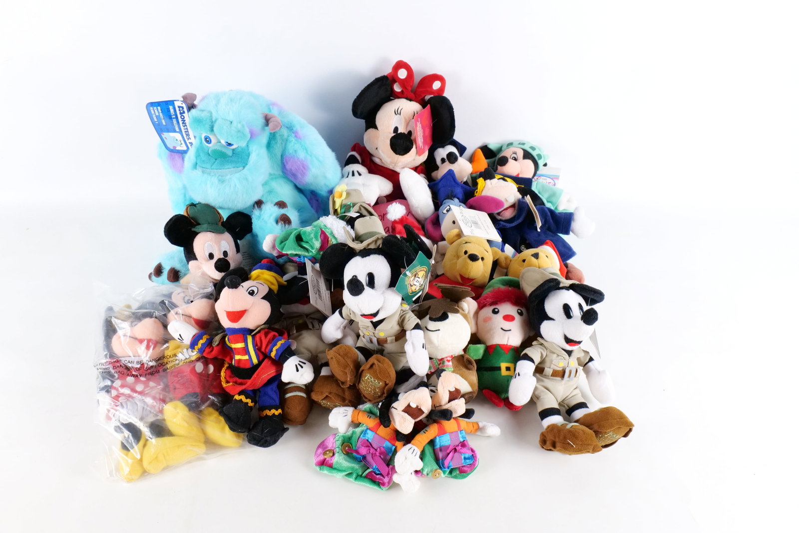 Lot of Disney Store Bean Bag Plush: Lot of Disney Store Bean Bag Plush. Including Statue of Liberty Minnie, Winnie the Pooh, Detective Mickey, Safari Mickey, Graduation Goofy, Safari Mini , Sully and more. Almost all have Disney Store t