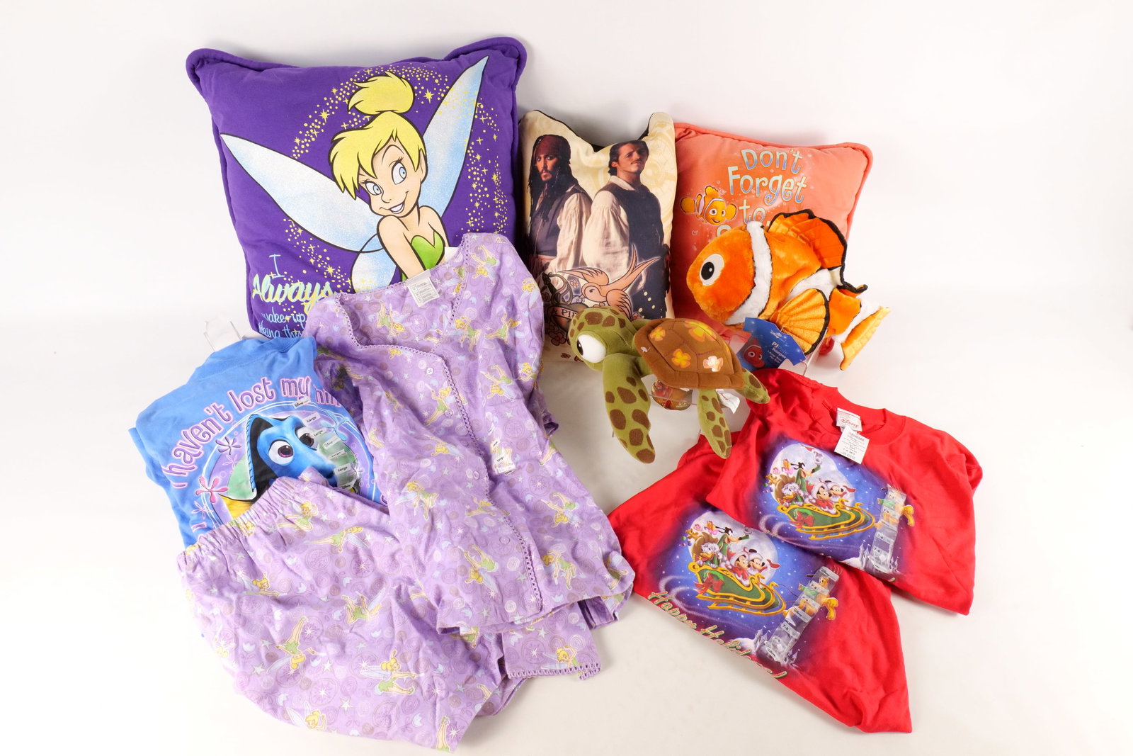 Lot of Disney Pillows, Plush, and T-Shirts: Lot of Disney Pillows, Plush, and T-Shirts. Including Finding Nemo, Tinkerbell, Pirates of the Caribbean, and more. Most appear to be in new condition. All invoices must be paid within 24 hours of the