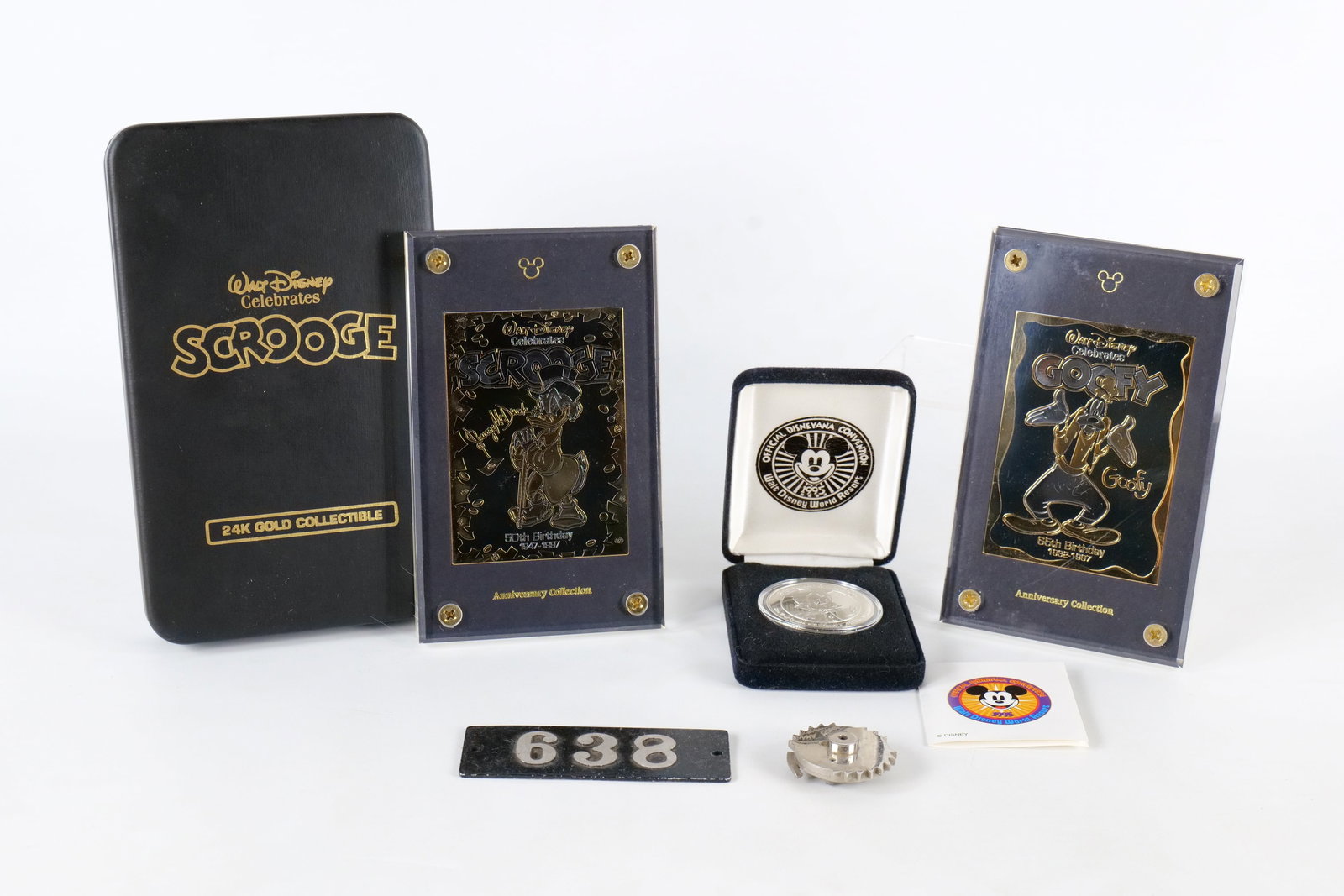 Lot of Disney Collectibles: Lot of Disney Collectibles. Including Scrooge and Goofy Anniversary Collection 24k Gold Plated Cards with Packaging, 1995 Medallion - 1 Troy Ounce, and Vintage Typewriter Part. The typewriter part sai