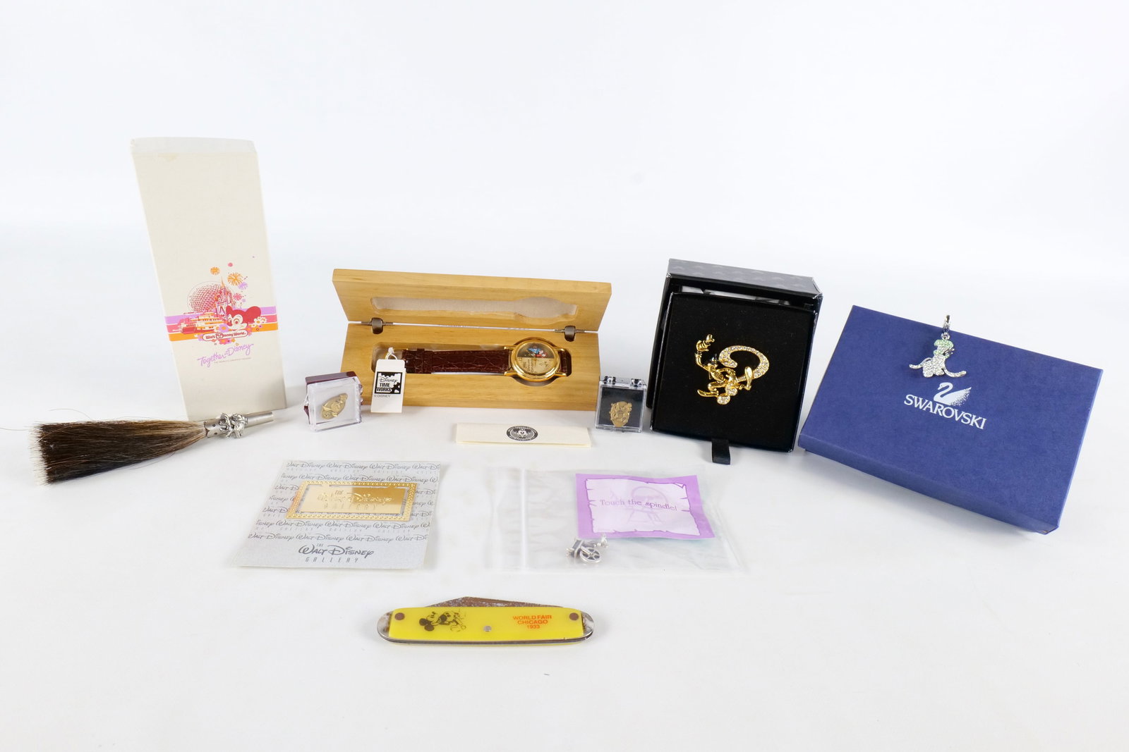 Lot of Disney Jewelry and Collectibles: Lot of Disney Jewelry and Collectibles. Including Goofy Pin by Napier, 1994 Swarovski Watch, Swarovski Goofy Head Pendant, Novelty World's Fair Pocket Knife, and More. All invoices must be paid within