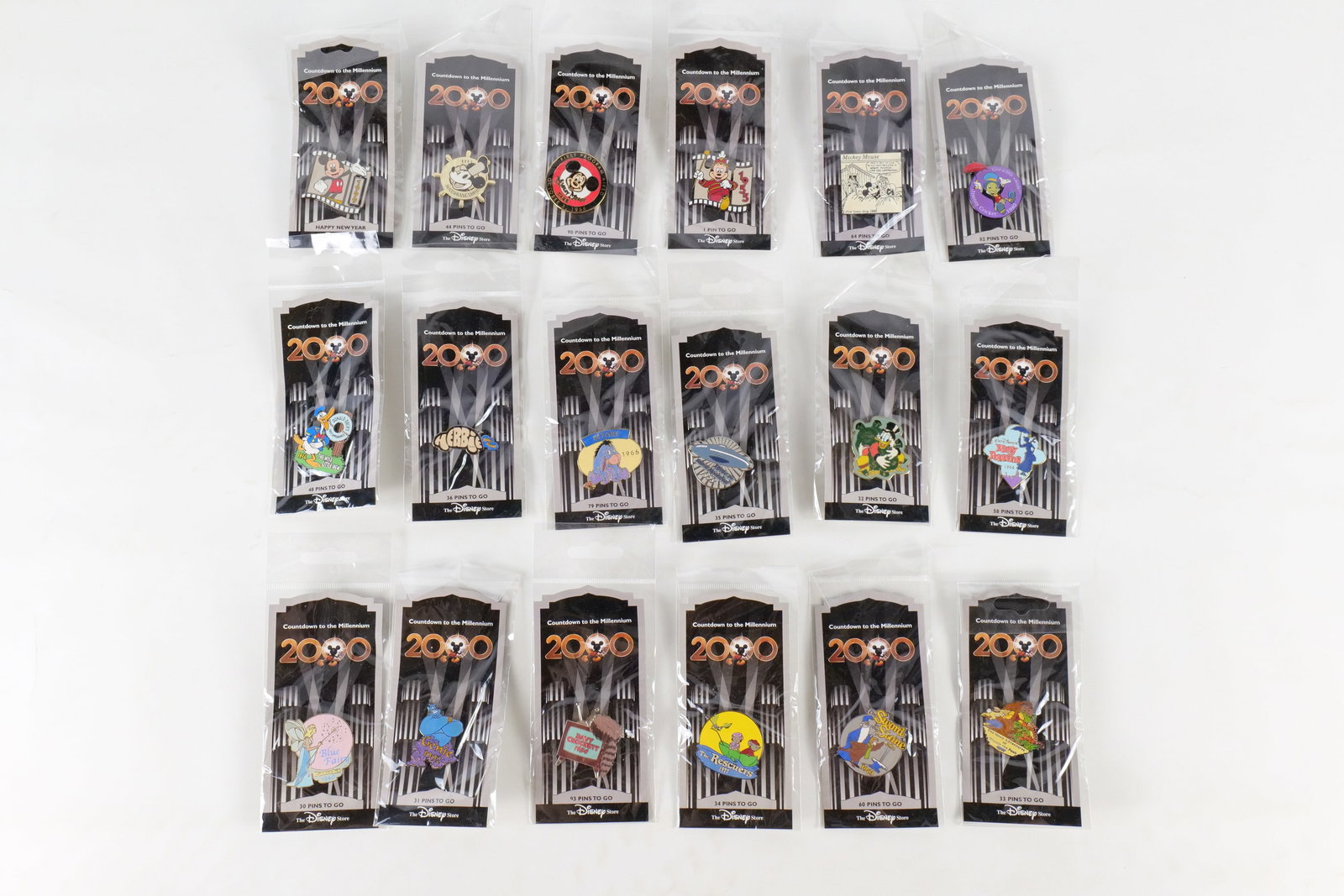 Lot of 18 Disney Countdown to the Millennium Pins: Lot of 18 Disney Countdown to the Millennium Pins. Including Scrooge Mc Duck, Merlin, Jiminy Cricket, Mary Poppins, The Rescuers, Blue Fairy, Genie, and more. All sealed in package. All invoices must 