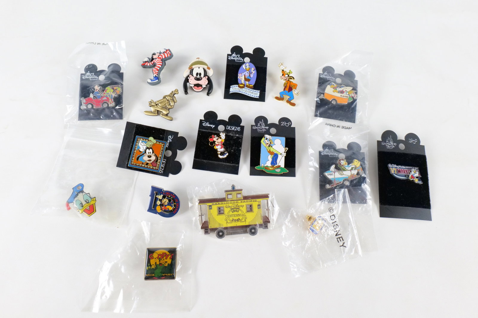 Lot of 17 Disney Pins: Lot of 17 Disney Pins. Including Various Goofy, Pluto, Daisy Duck, Half Marathon, Rare Centennial Train Carolwood Pacific, Minnie Mouse, and more. Many pins come on card back or are sealed in package.