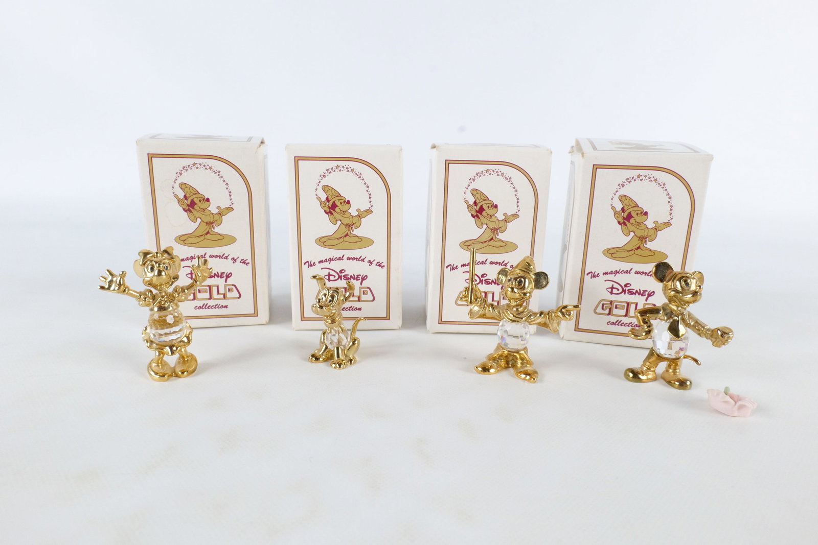 Lot of 4 Disney Lencia Austria 24K Gold Plated and Crystal Figurines: Lot of 4 Disney Lencia Austria 24K Gold Plated and Crystal Figurines. Including Sorcerer Mickey, Pluto, Minnie Mouse, and Mickey Mouse with Flower - flower needs to be reattached. Tallest measures 1.7