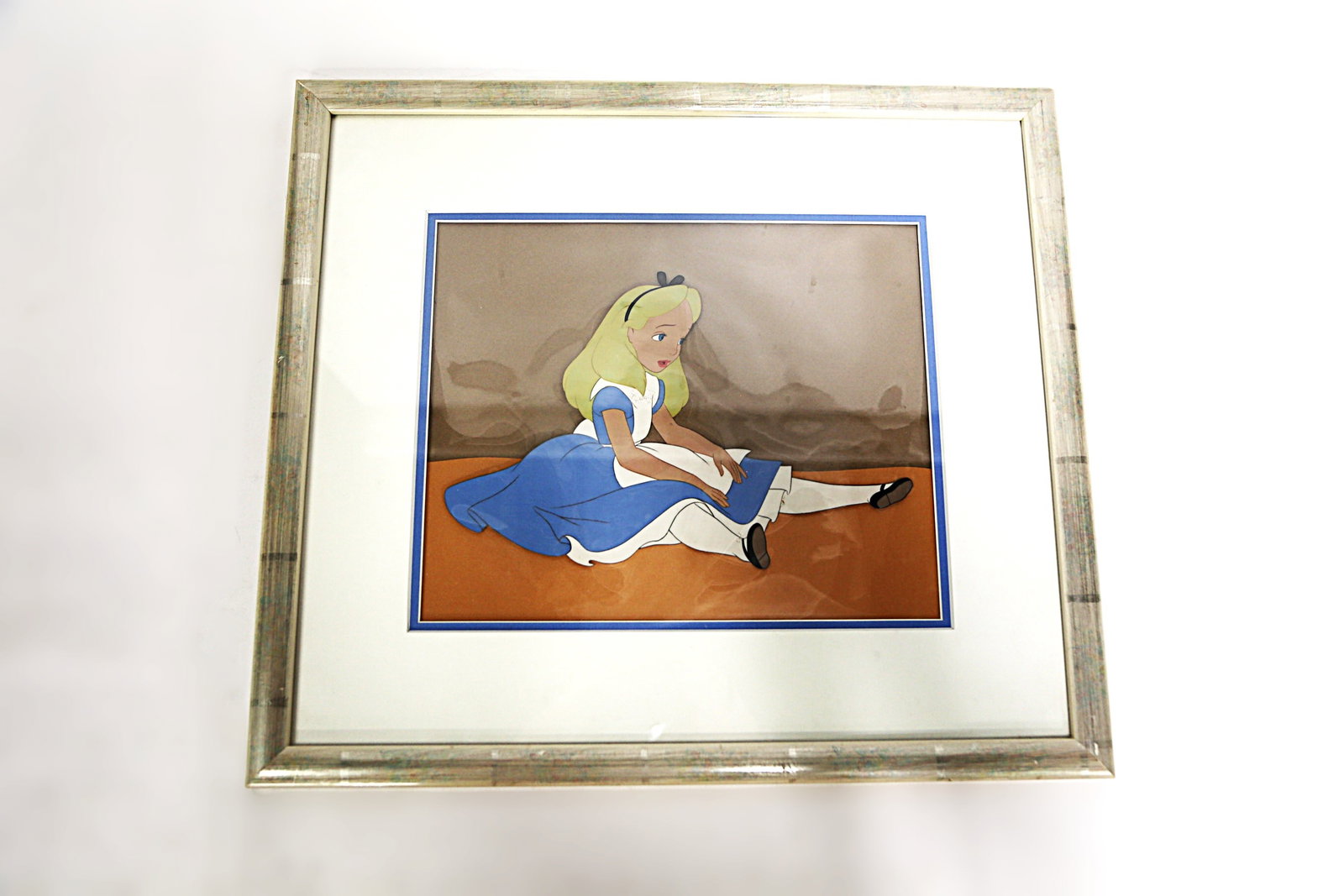 Disney Original Production Cel - Alice in Wonderland: Disney Original Production Cel - Alice in Wonderland. Unsigned and No COA. Appears to be pre-Disney mark era. Framed and matted. Measures 15 1/2 inches tall by 17 1/2 inches wide. All invoices must be