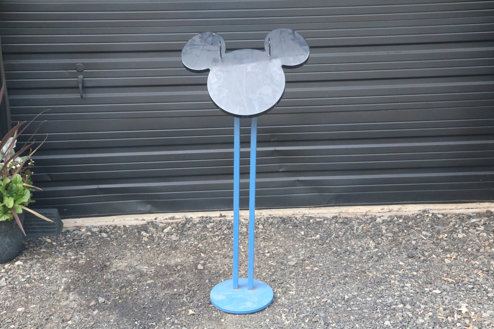 Vintage Disney Store Retail Display Stand: Vintage Disney Store Retail Display Stand with a Mickey Silhouette. Circa 1990s through 2000s. Top is made of a plastic or acrylic. The base is made of metal. Measures 50 inches tall by 22 and 1/2 inc