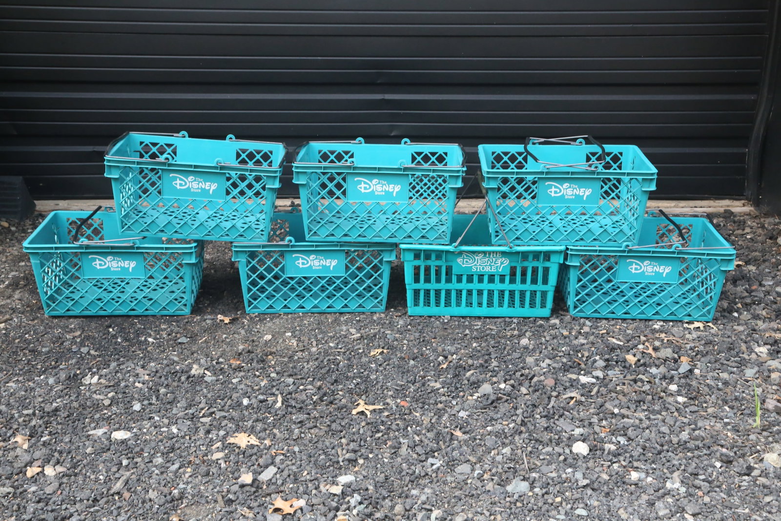 Lot of Vintage Disney Store Commercial Shopping Baskets: Lot of Vintage Disney Store Commercial Shopping Baskets. All have Disney Store logo displayed on the side. Teal colored with metal bail handles. Each one measures 9 inches tall by 18 inches long by 12