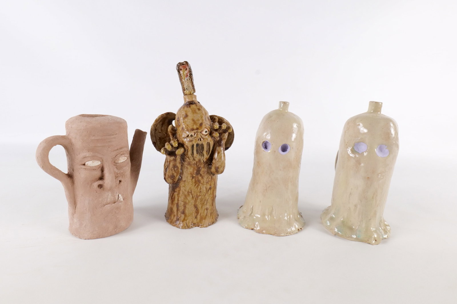 Lot of 4 Ed Berdej Studio Art Pottery Spooky Character Mini Jugs and Vessel: Lot of 4 Ed Berdej Studio Art Pottery Spooky Character Mini Jugs and Vessel. Depicting monsters and ghosts. Gloss and matte finish. Tallest measures 7 inches. Ed Berdej was an American graphic artist,