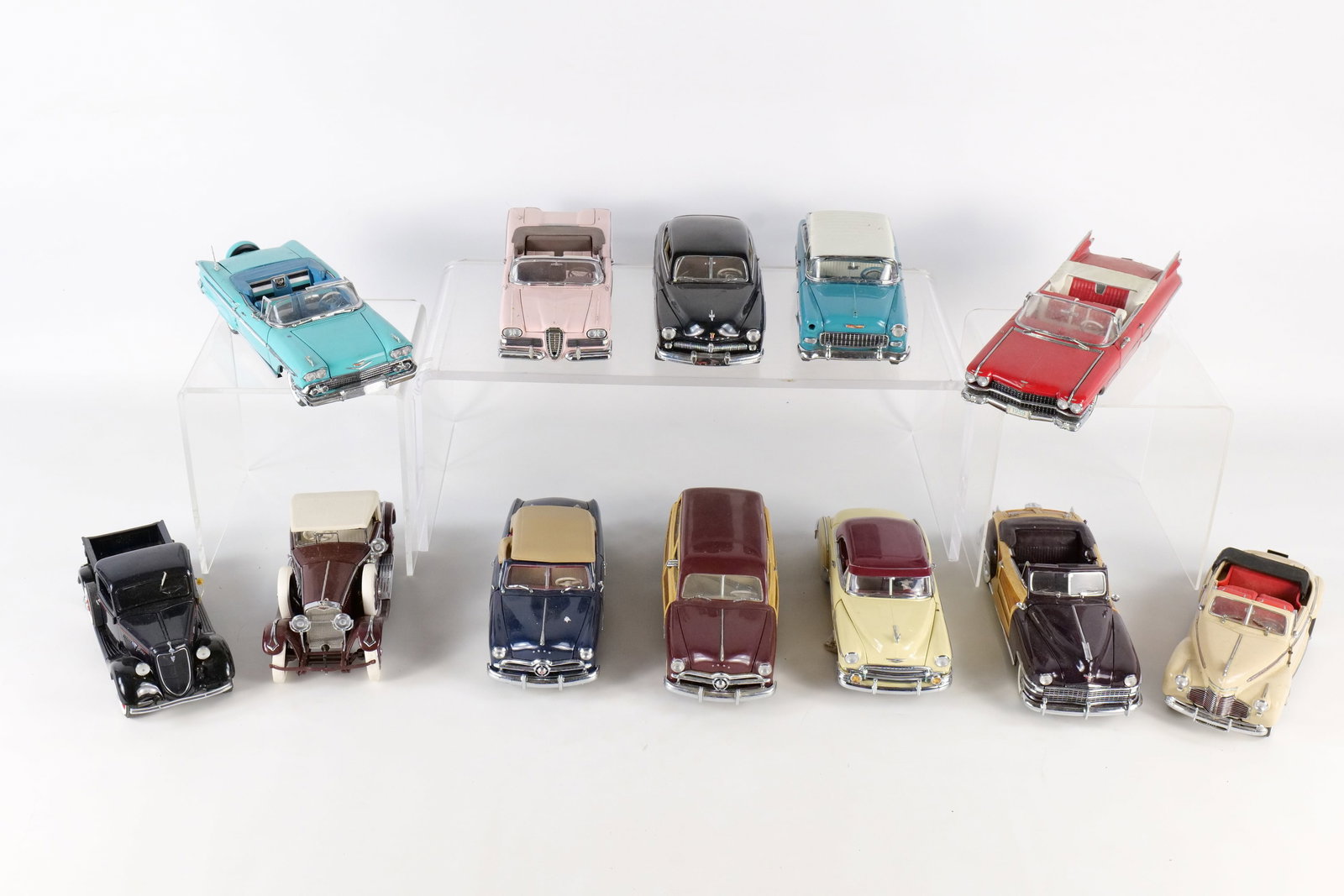 A Collection of Twelve 1:24 Scale Franklin and Danbury Mint Precision Models Die-Cast Cars: This collection consists of twelve 1:24 scale die-cast metal model automobiles from Franklin Danbury, representing American classics from the 1930s through the late 1950s. The assortment includes a 19
