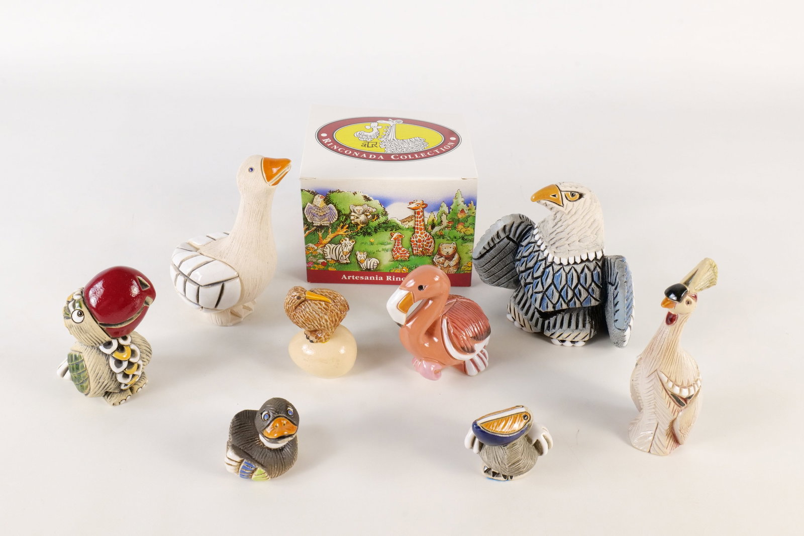 A Collection of Artesnia Rinconada Figurines: A collection of Artesania Rinconada ceramic bird figurines. The set features various species, including ducks, flamingo, eagle peacock and more. Largest is 4.5 inches tall. with carved textures and en