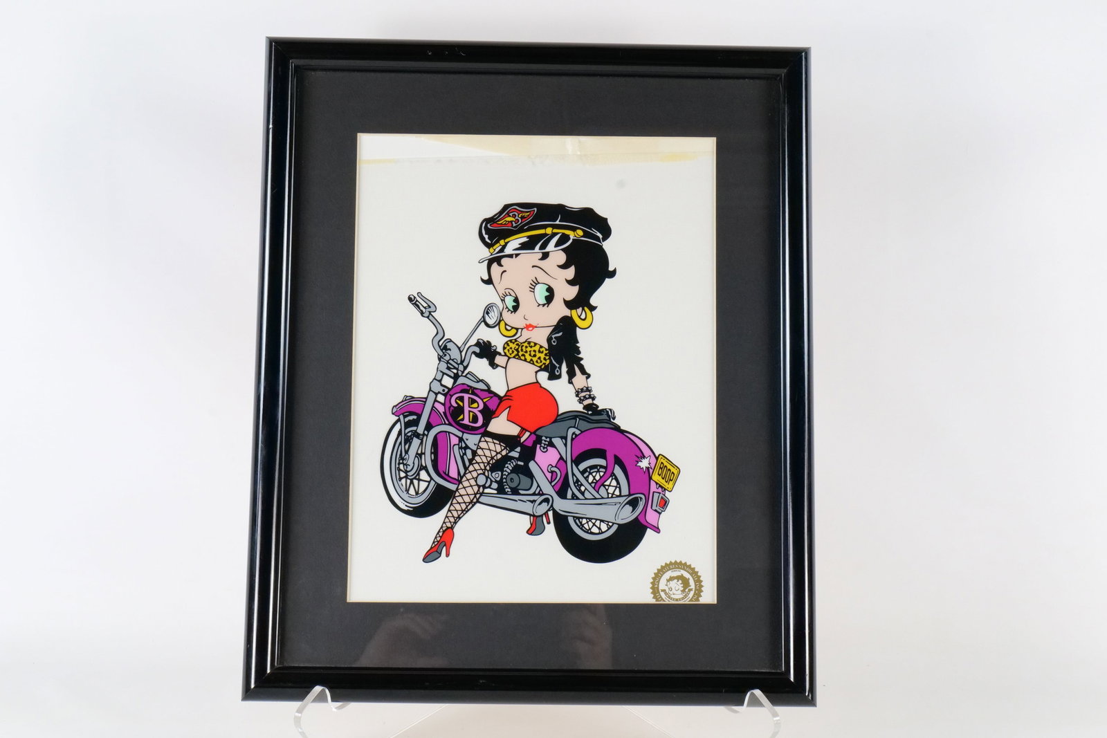 Betty Boop "Biker/Motorcycle Mama" Framed Sericel: Betty Boop "Biker/Motorcycle Mama" Framed Limited Edition Sericel. It has the King Features Syndicate / Fleischer Studios Sericel Seal in the bottom right corner. The Betty Boop paper is loose inside