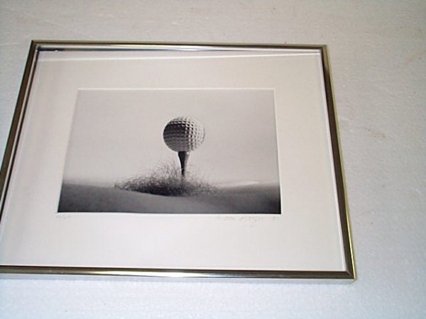 Black and white photograph depicting a golf ball te