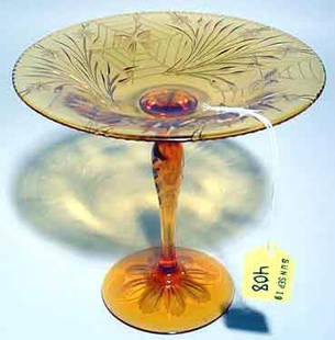 AMERICAN AMBER GLASS COMPOTE: AMERICAN AMBER GLASS COMPOTE, having a spider web and floral wheel etched design, with butterfly detailing; 6-1/2 inch height; PROVENANCE; Estate of Chester Weber, Beaumont, TX