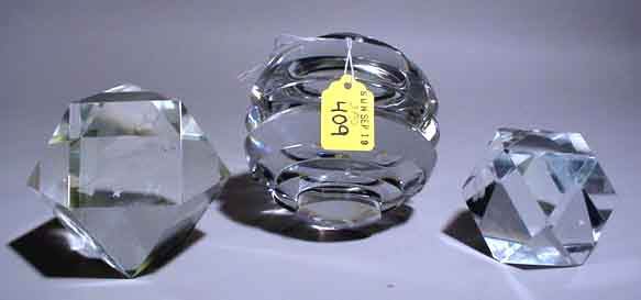 LOT OF THREE GLASS PAPER WEIGHTS: LOT OF THREE GLASS PAPER WEIGHTS, one of deep cut circular design, the other two being of faceted cuts, one with fish and star design; height of tallest 4-1/2 inches