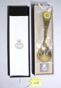 GEORG JENSEN GOLD-PLATED STERLING SPOON: GEORG JENSEN GOLD-PLATED STERLING SPOON, decorated with an enamel daisy, bearing the Jensen mark, in the original box; 5-3/4 inch length