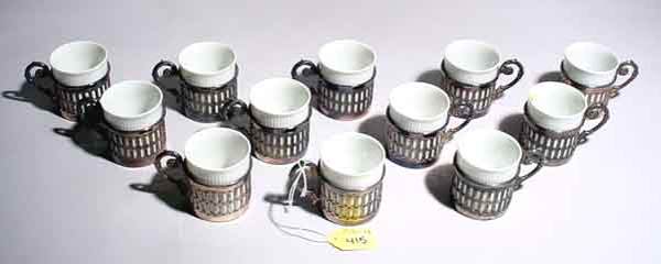 SET OF TWELVE SILVERPLATE AND GERMAN CHINA DEMITAS: SET OF TWELVE SILVERPLATE AND GERMAN CHINA DEMITASSE CUPS AND SAUCERS; 2-1/2 inch height; PROVENANCE; Estate of Chester Weber, Beaumont, TX