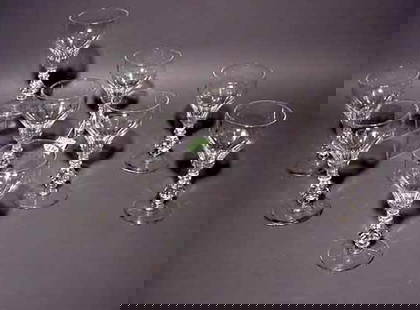 SET OF EIGHT FLUTED CRYSTAL WINE STEMS, having f: SET OF EIGHT FLUTED CRYSTAL WINE STEMS, having faceted stems; 6 inch height NOTE: Sold for the benefit of the Museum of Fine Arts, Houston (chip to one base)
