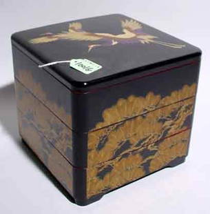 JAPANESE LACQUER DECORATED THREE-SECTION SQUARE: JAPANESE LACQUER DECORATED THREE-SECTION SQUARE PICNIC BOX, the decorations depicting ferns encircling the box with flying cranes on the top; 7 inch height; 7-3/4 inches square (Est. 40-60)