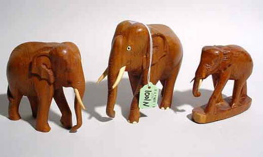 ASSEMBLED LOT OF THREE CARVED FIGURES OF ELEPHAN: ASSEMBLED LOT OF THREE CARVED FIGURES OF ELEPHANTS WITH IVORY TUSKS; dimensions of tallest: 6 inch length; 5 inch height (Est. 75-125 the Lot)