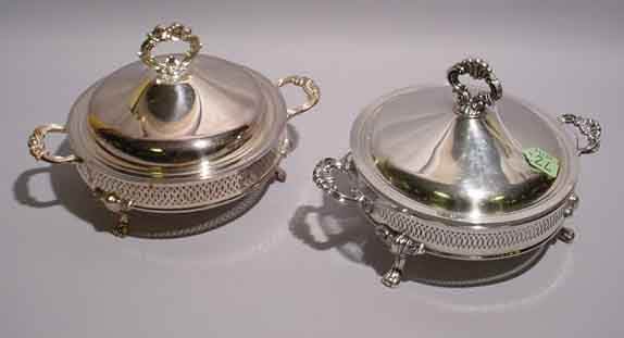 NEAR PAIR OF SILVERPLATED COVERED CASSEROLE BASES,: NEAR PAIR OF SILVERPLATED COVERED CASSEROLE BASES, having reticulated sides, supported on cabriole legs, one with a pyrex liner; 8 inch height; 9 inch diameter