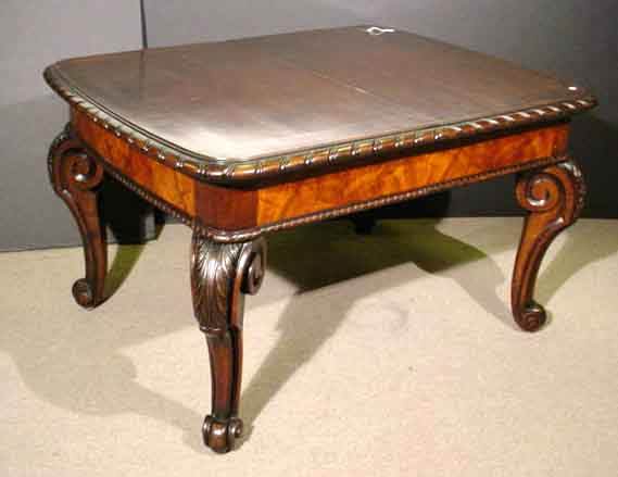 BOLDLY STYLED EUROPEAN CARVED FIGURED MAHOGANY AN: BOLDLY STYLED EUROPEAN CARVED FIGURED MAHOGANY AND WALNUT DRAW-END DINING TABLE, late 19th century, having a rectangular crossbanded top, with rounded corners and gadrooned edges, with a deep figured