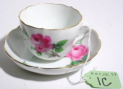 MEISSEN DECORATED PORCELAIN CUP AND SAUCER: MEISSEN DECORATED PORCELAIN CUP AND SAUCER, late 19th/early 20th century, each piece having a shaped and gilded edge with a rose decoration, signed; diameter of saucer, 4 inches; height of cup 2