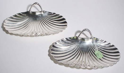 PAIR OF SILVERPLATED CANDY DISHES: "PAIR OF SILVERPLATED CANDY DISHES, by Reed and Barton, each having a shell form with rope design handle;6-1/2 inch width; 11 inch length PROVENANCE: Estate of Chester Weber, Beaumont, Texas