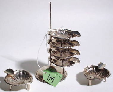 STACKED SET OF SIX STERLING SILVER SHELL FORM SMALL: STACKED SET OF SIX STERLING SILVER SHELL FORM SMALL ASHTRAYS, on a common pole holder; 5-1/2 inch overall height (Est. 50-75)PROVENANCE: Jenny Asby Webb, Houston, Texas