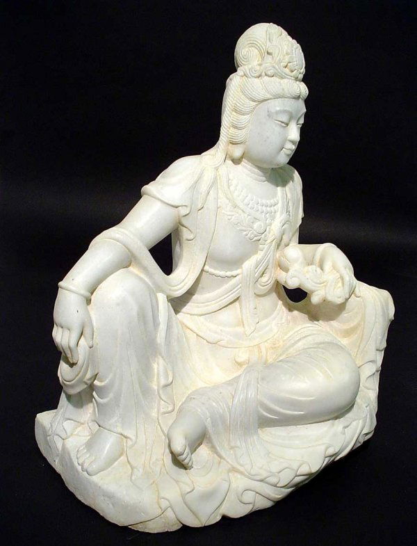 CHINESE HAND-SCULPTED WHITE MARBLE FIGURE OF A SEA: CHINESE HAND-SCULPTED WHITE MARBLE FIGURE OF A SEATED BODHISATTVA, mid 20th century, the figure depicted in flowing robes, casually lounging, holding a sash in one hand, a lotus branch in the other, h