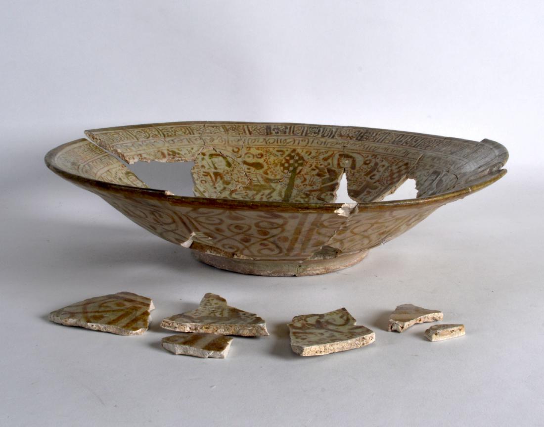 A PERSIAN LUSTE TYPE CIRCULAR BOWL 10th/12th Century,: A PERSIAN LUSTE TYPE CIRCULAR BOWL 10th/12th Century, painted with figures and calligraphy type borders. 1Ft 1ins diameter.
