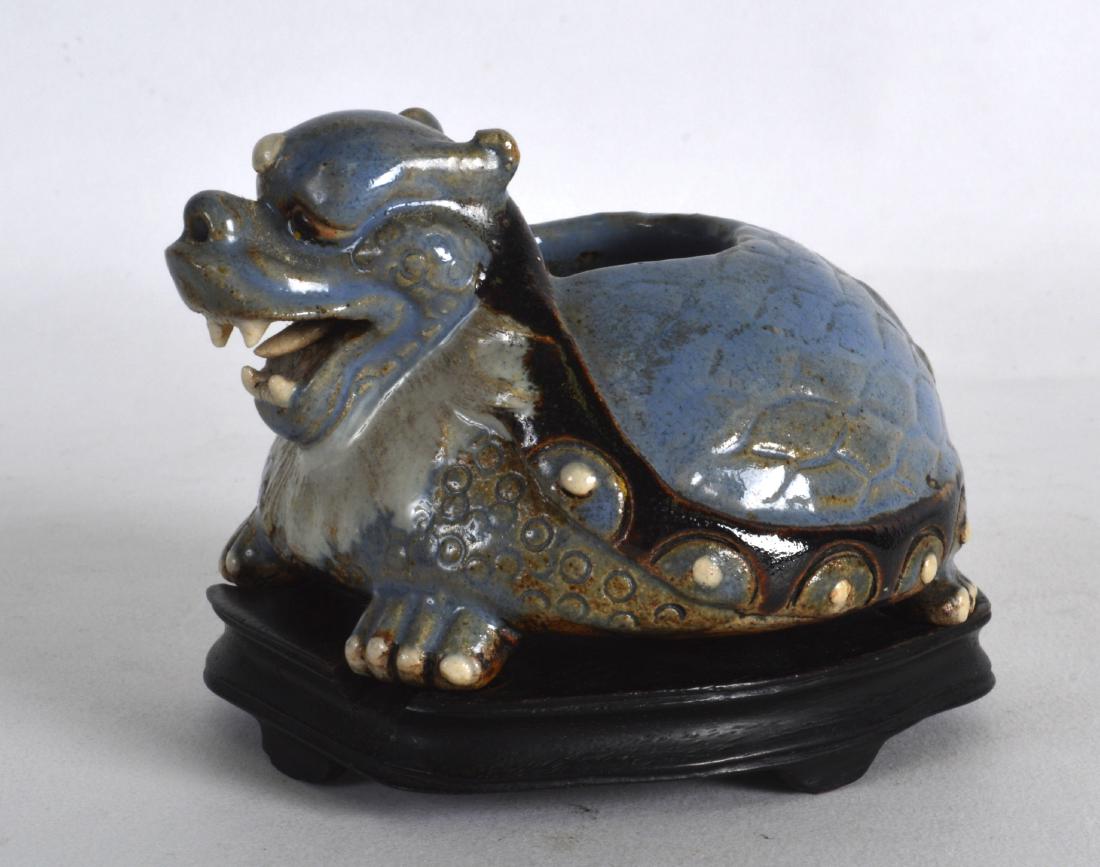 AN UNUSUAL CHINESE QING DYNASTY ROBINS EGG TYPE BRUSH: AN UNUSUAL CHINESE QING DYNASTY ROBINS EGG TYPE BRUSH WASHER in the form of a mythical beast, upon a fitted hardwood base. 3.75ins wide.
