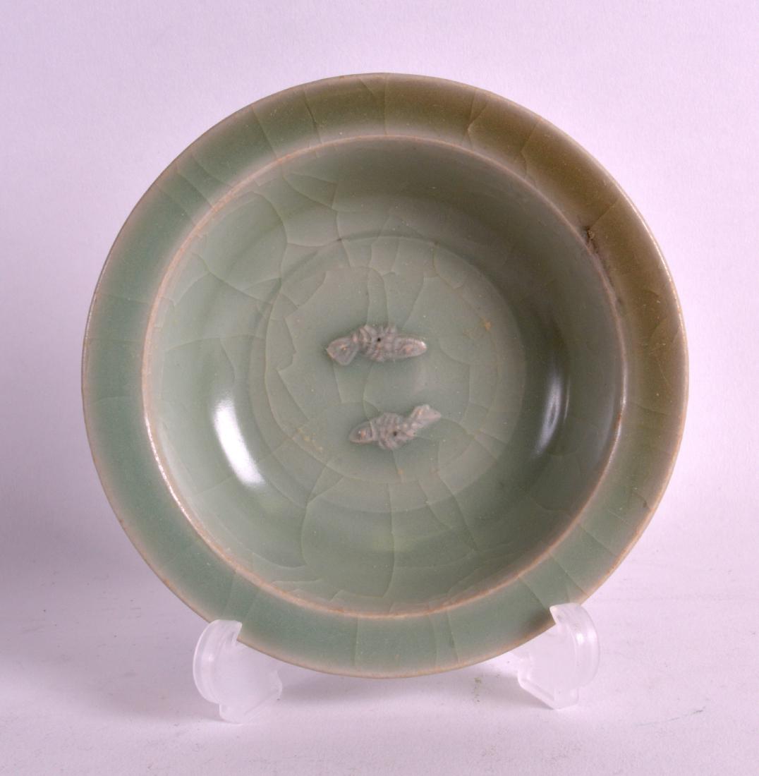 A CHINESE YUAN/MING DYNASTY CELADON DISH decorated with (1 of 2)