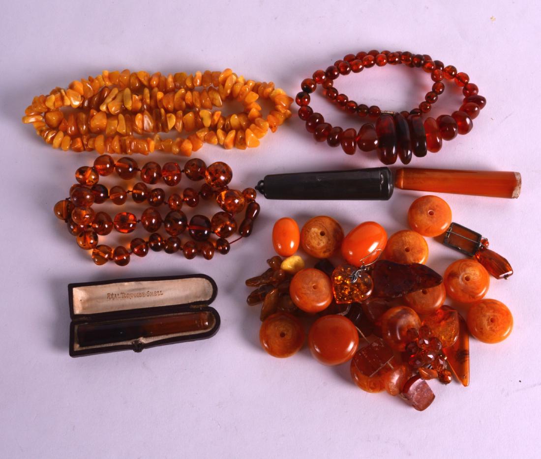 A COLLECTION OF CARVED AMBER NECKLACES together with (1 of 1)