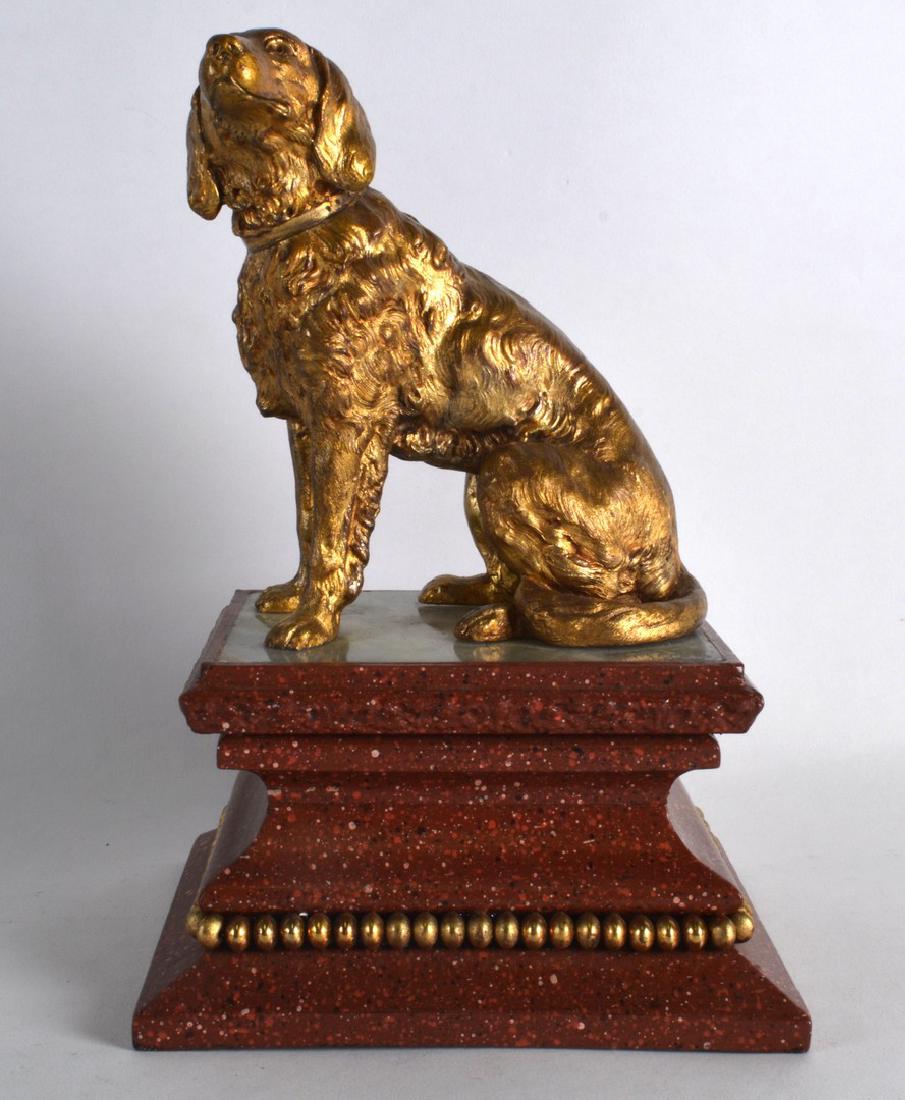 A MID 19TH CENTURY EUROPEAN GILT FIGURE OF A HOUND: A MID 19TH CENTURY EUROPEAN GILT FIGURE OF A HOUND modelled upon an onyx and faux marble base. 10.5ins high.