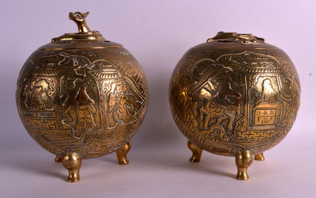 A PAIR OF 19TH CENTURY CHINESE BRONZE INCENSE BURNERS: A PAIR OF 19TH CENTURY CHINESE BRONZE INCENSE BURNERS AND COVERS of globular form, decorated with figures on horseback. 8.75ins high.
