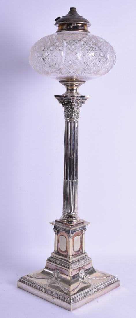 A GOOD 19TH CENTURY ENGLISH SILVER PLATED CUT GLASS OIL: A GOOD 19TH CENTURY ENGLISH SILVER PLATED CUT GLASS OIL LAMP in the manner of Elkington, decorated with classical urns and foliage. 55 cm high.