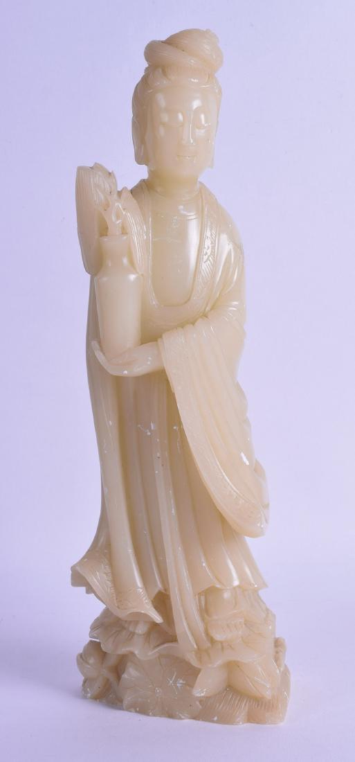 AN EARLY 20TH CENTURY CHINESE CARVED SOAPSTONE FIGURE: AN EARLY 20TH CENTURY CHINESE CARVED SOAPSTONE FIGURE OF GUANYIN modelled holding a vase of flowers. 31 cm high.