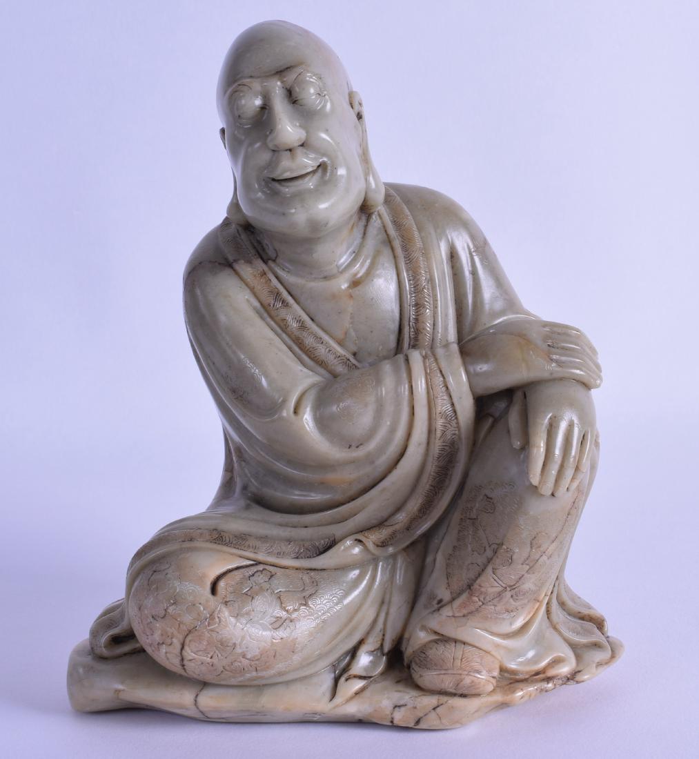 A GOOD CHINESE QING DYNASTY CARVED SOAPSTONE FIGURE OF: A GOOD CHINESE QING DYNASTY CARVED SOAPSTONE FIGURE OF A BUDDHA modelled with his hand upon his knee, engraved with foliage. 16.5 cm x 12.5 cm.