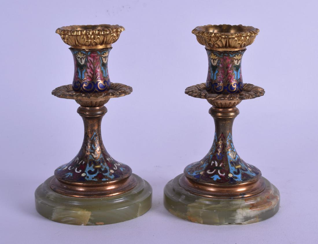A PAIR OF 19TH CENTURY FRENCH CHAMPLEVE ENAMEL ONYX: A PAIR OF 19TH CENTURY FRENCH CHAMPLEVE ENAMEL ONYX DWARF CANDLESTICKS decorated with foliage and vines. 12.75 cm high.