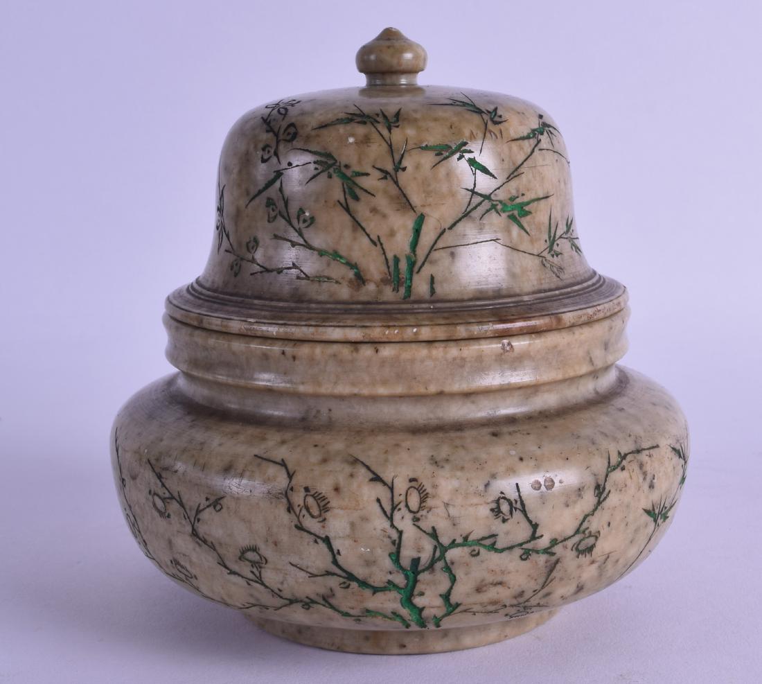 AN UNUSUAL 19TH CENTURY CHINESE CARVED SOAPSTONE JAR: AN UNUSUAL 19TH CENTURY CHINESE CARVED SOAPSTONE JAR AND COVER decorated with extensive foliage and vines. 12 cm wide.