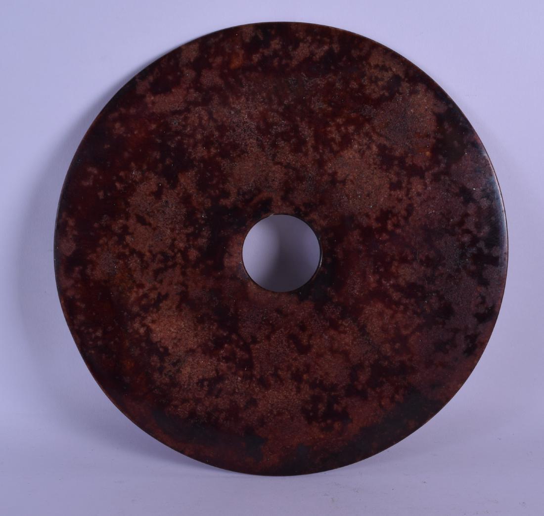 A LARGE CHINESE RED GLAZED HARDSTONE BI DISC. 29 cm (1 of 2)