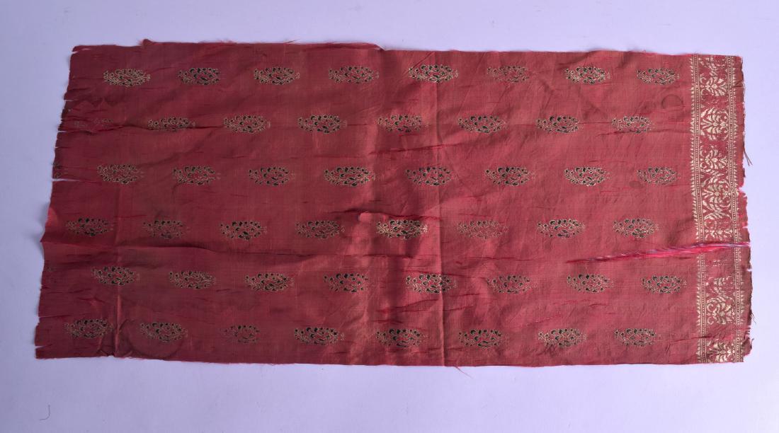 AN EARLY CENTRAL ASIAN RECTANGULAR CORAL GROUND: AN EARLY CENTRAL ASIAN RECTANGULAR CORAL GROUND FRAGMENT possibly Persian, depicting sparse gilt and green floral motifs. 62 cm x 28 cm.
