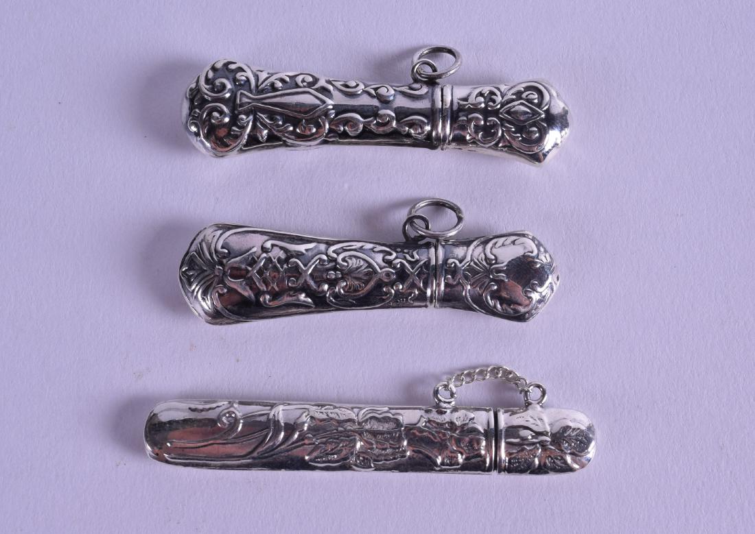 THREE NOVELTY SILVER NEEDLE CASES. 6.25 cm long. (3): THREE NOVELTY SILVER NEEDLE CASES. 6.25 cm long. (3)